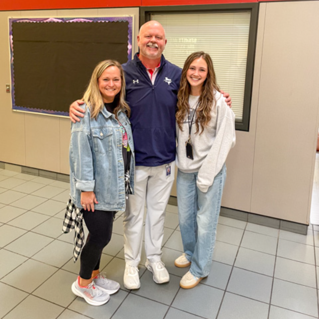 superintendent shawn pratt takes a photo with scott johnson teachers 