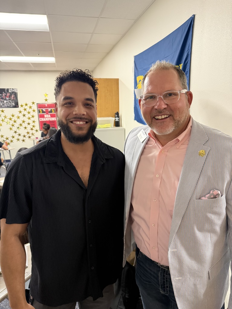corey homer takes a photo with teachers 