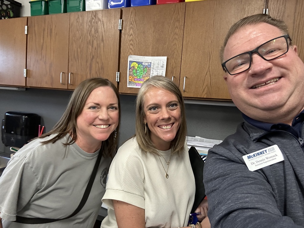 Dr. Dennis Womack takes a photo with teachers 