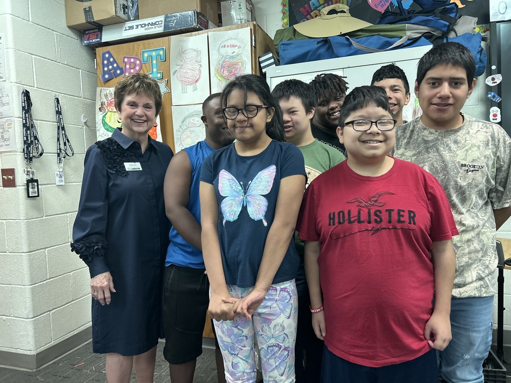 lynn sperry takes a photo with students from faubion middle school 