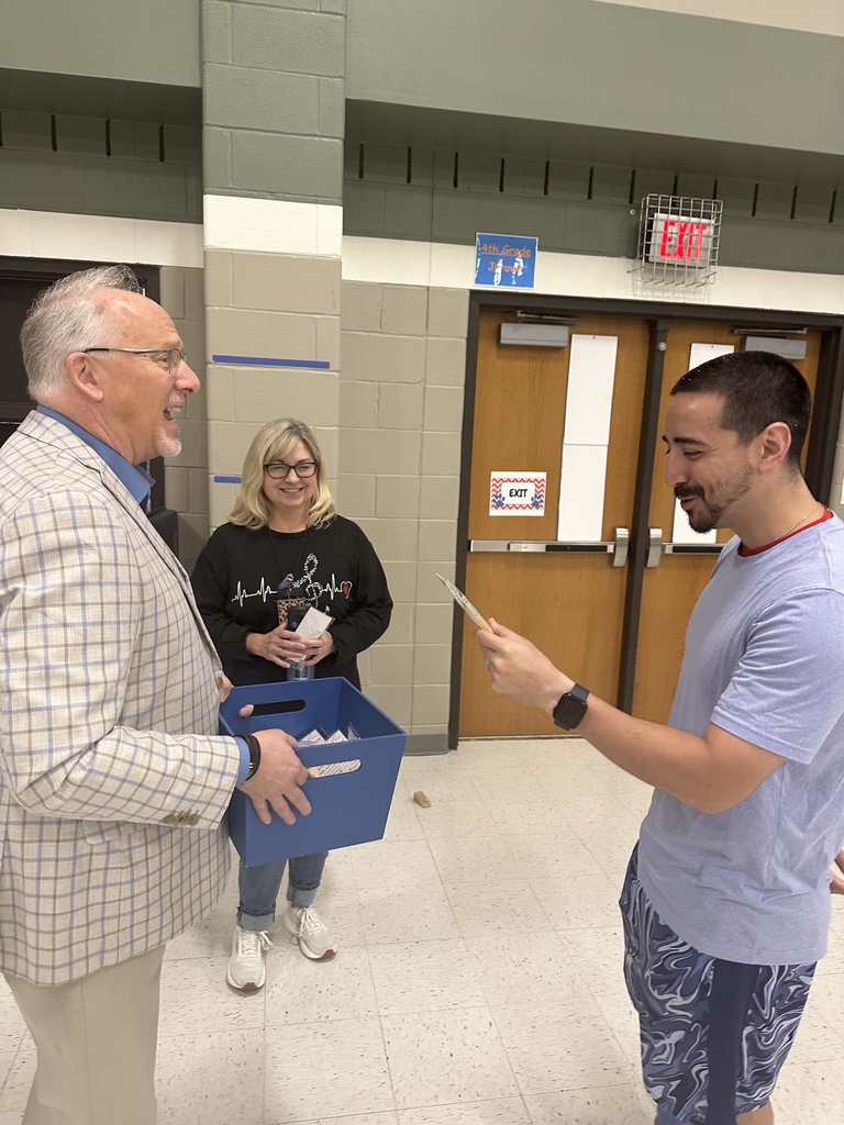 kenneth ussery takes a photo with a teacher 