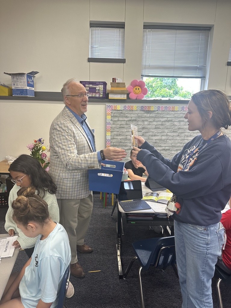 kenneth ussery takes a photo with a teacher 