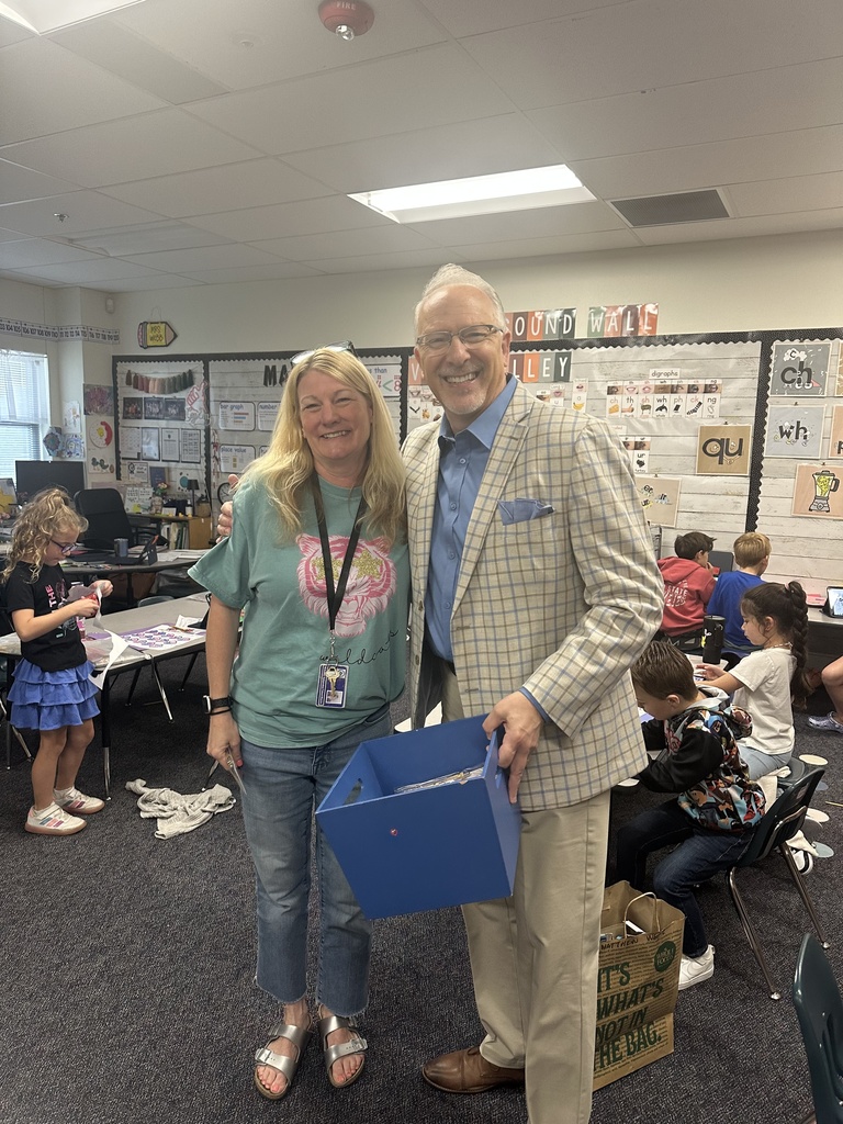 kenneth ussery takes a photo with a teacher 