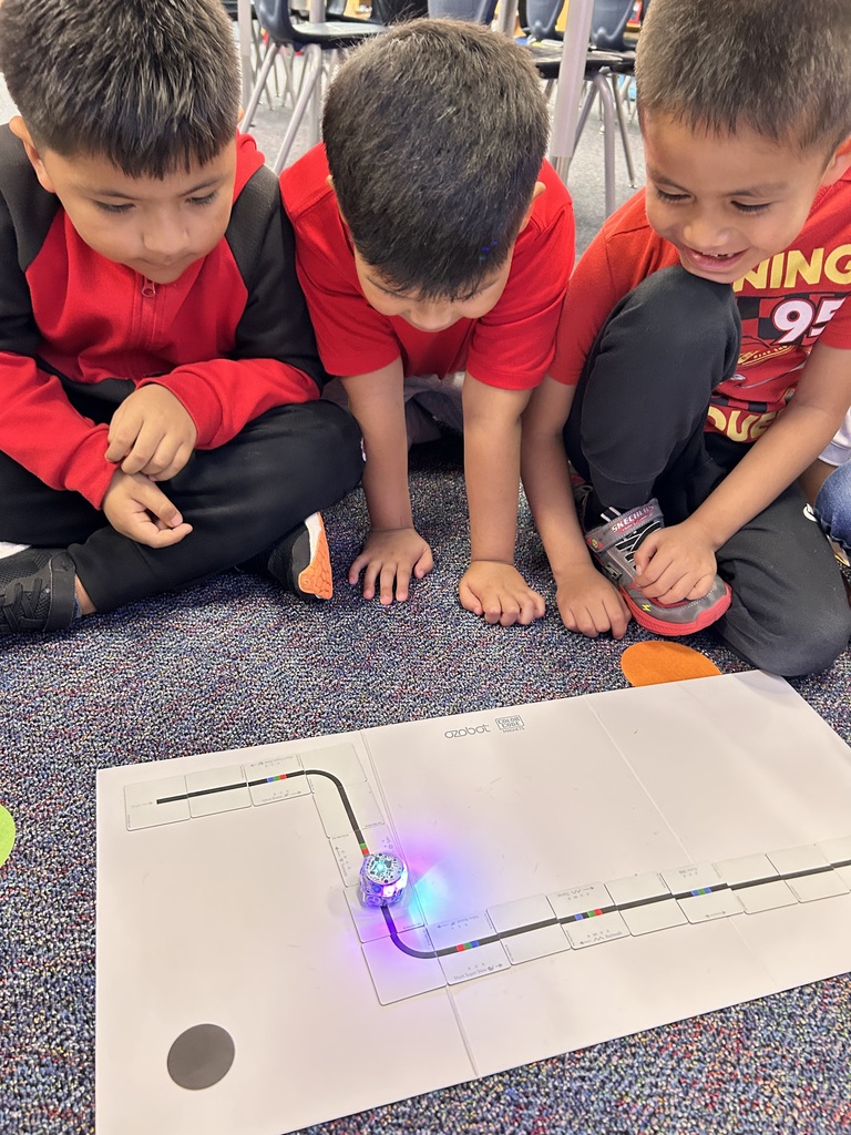 Kindergarteners learning how to code an Ozobot