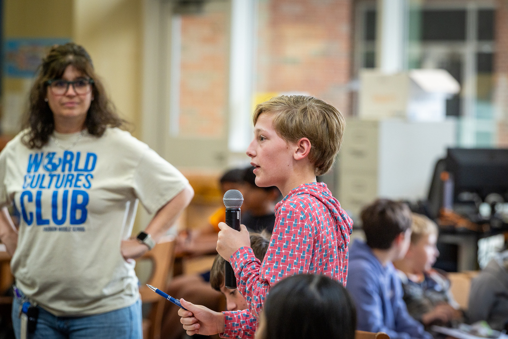 boy standing with microphone asking a question