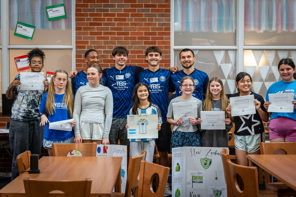 players posing with three winning project students