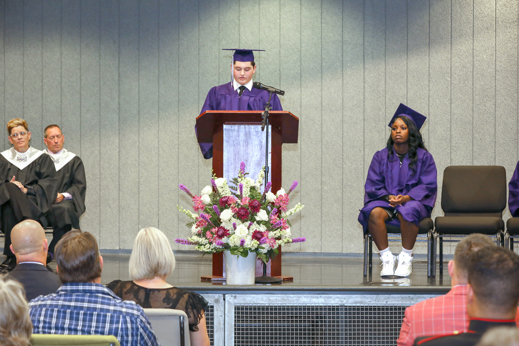 graduate at the podium speaking