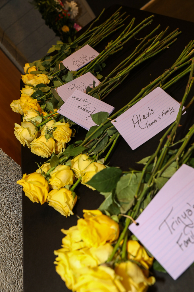 yellow roses laying on table for graduates to hand to parents
