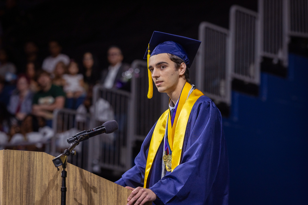 male graduate at the podium speaking