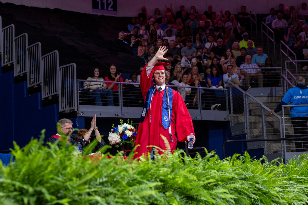 final boyd graduate waving at the crowd