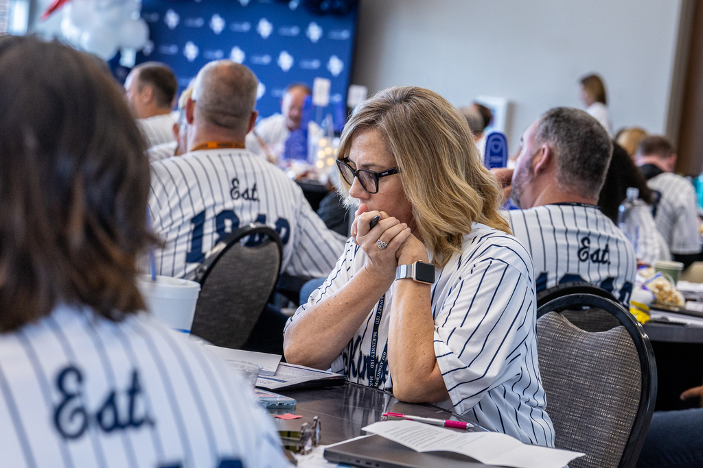 attendee at table looking at document