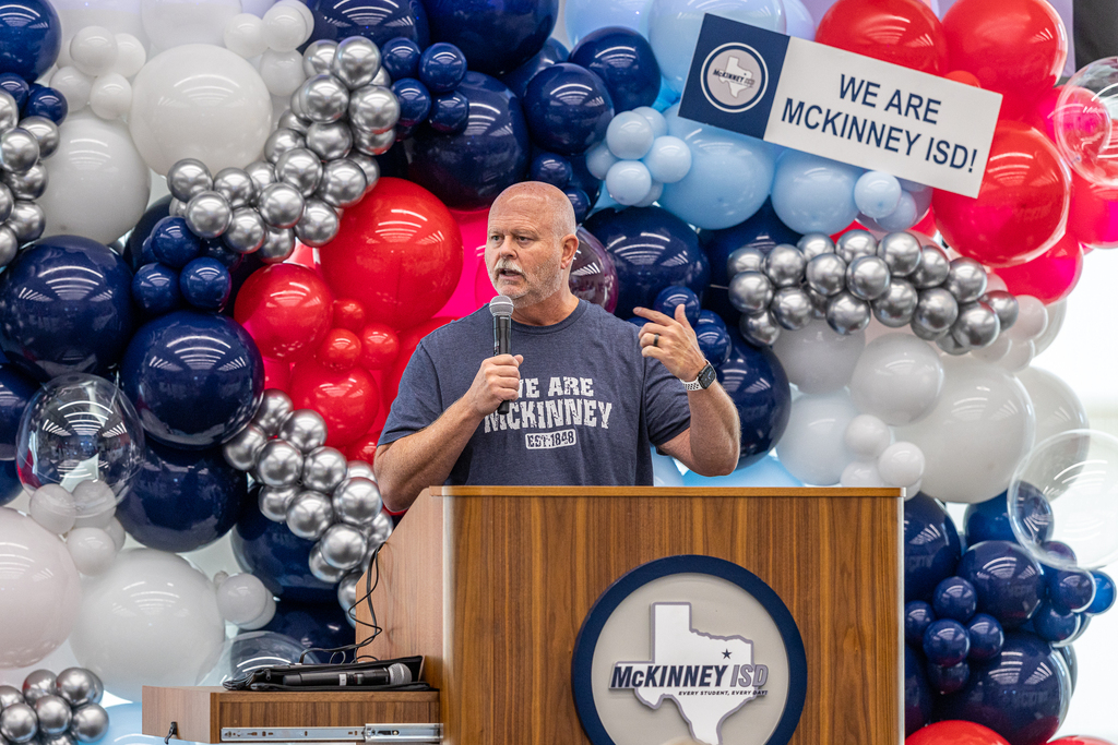 Pratt at podium speaking