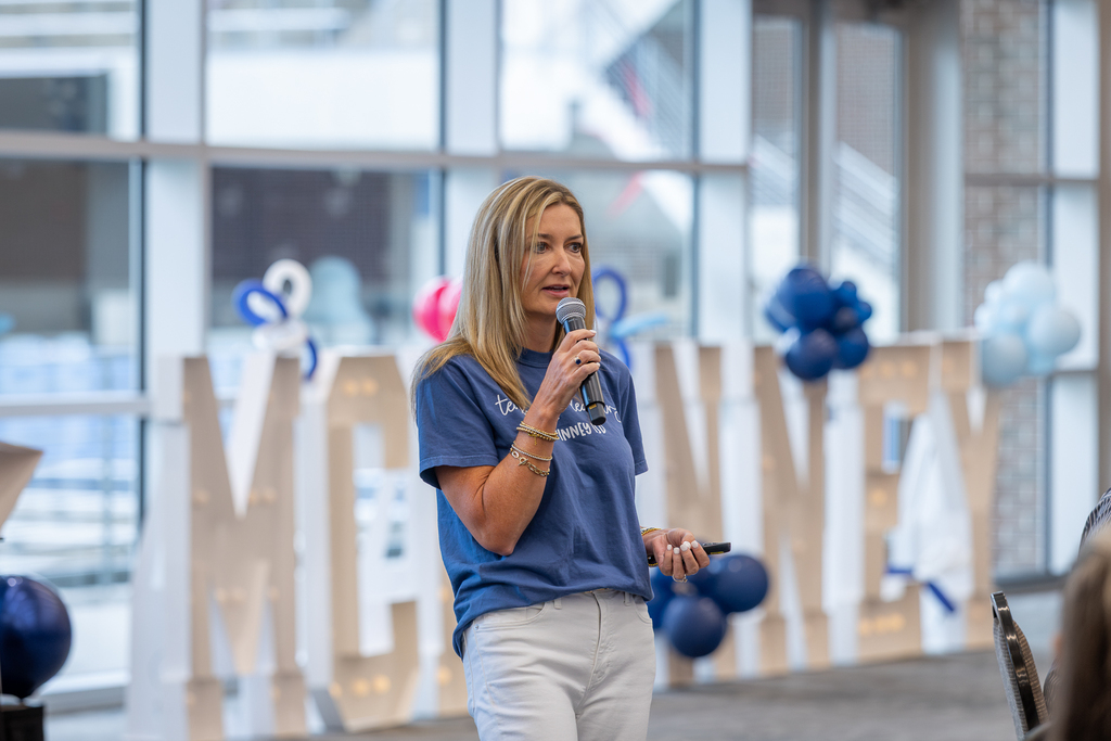Dr. Amber Epperson with microphone speaking