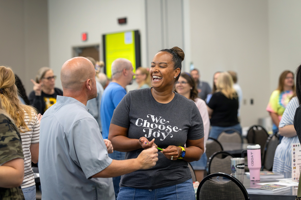 two teachers talking and laughing