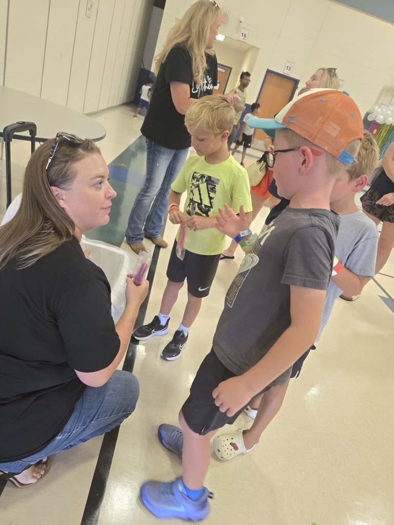 ms. Biggers handing out Popsicles