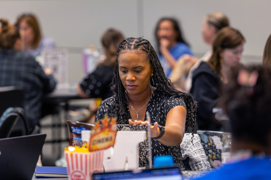 female teacher working on computer