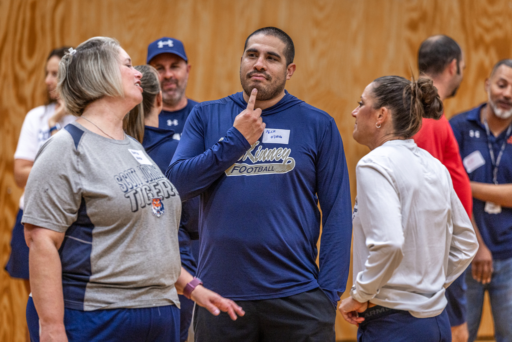 PE teacher with finger on chin thoughtfully