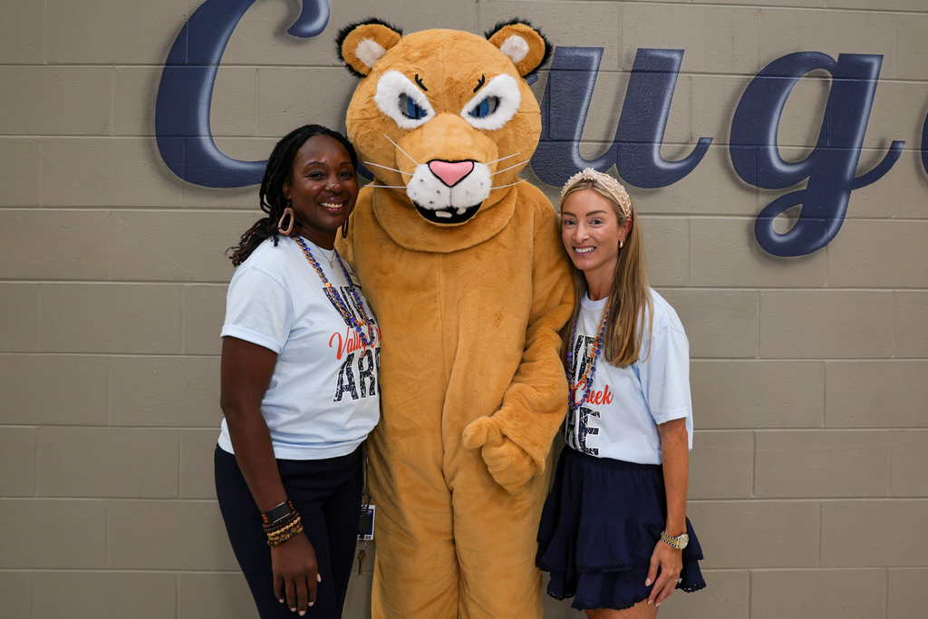 principal dr ebonee king and assistant principal ashley garcia take a photo with the valley creek cougar mascot