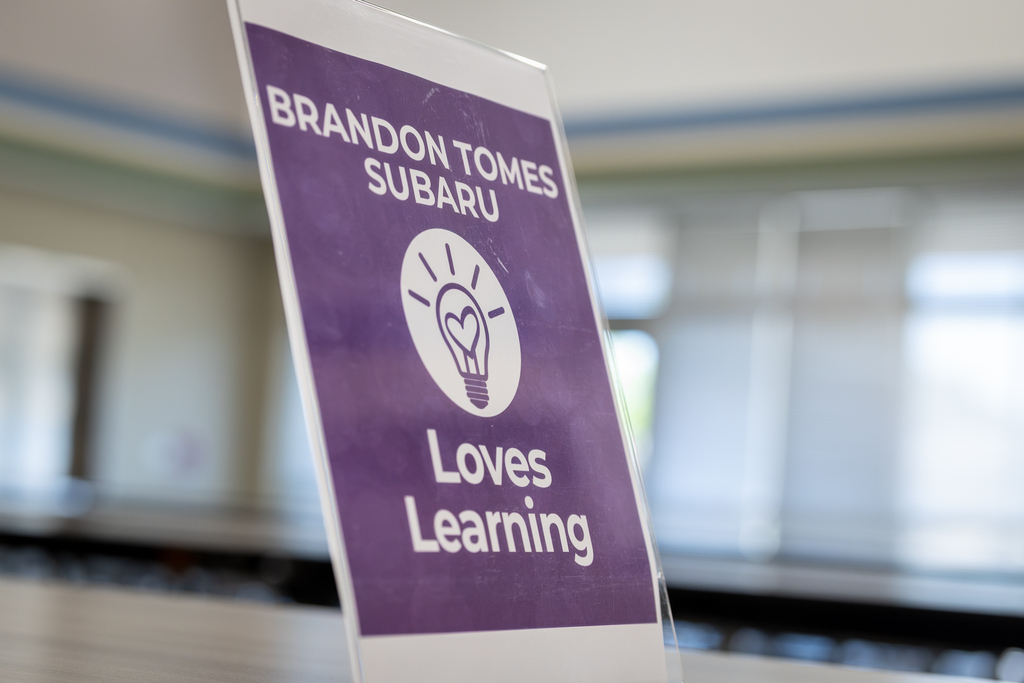 sign that reads Brandon Tomes Subaru loves learning