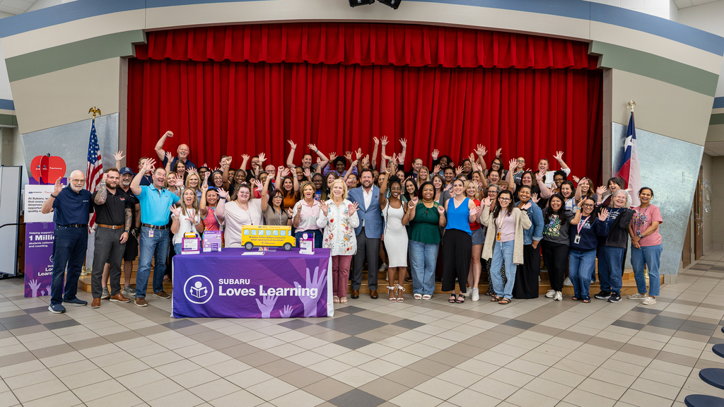 entire faculty cheering in front of stage