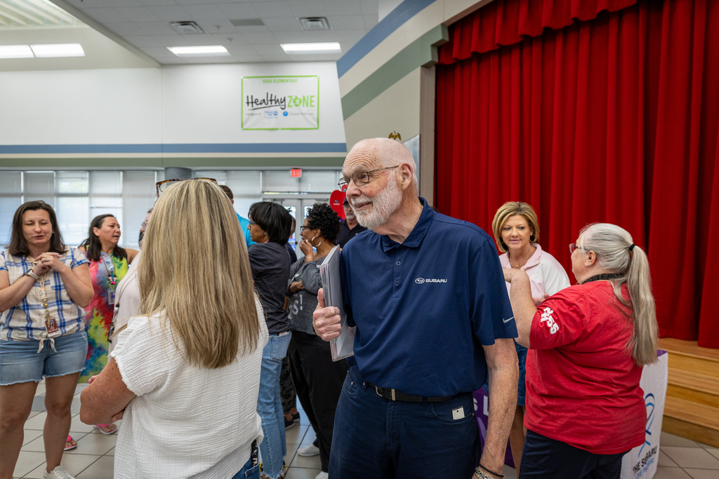 Subaru representative smiling and talking to teacher