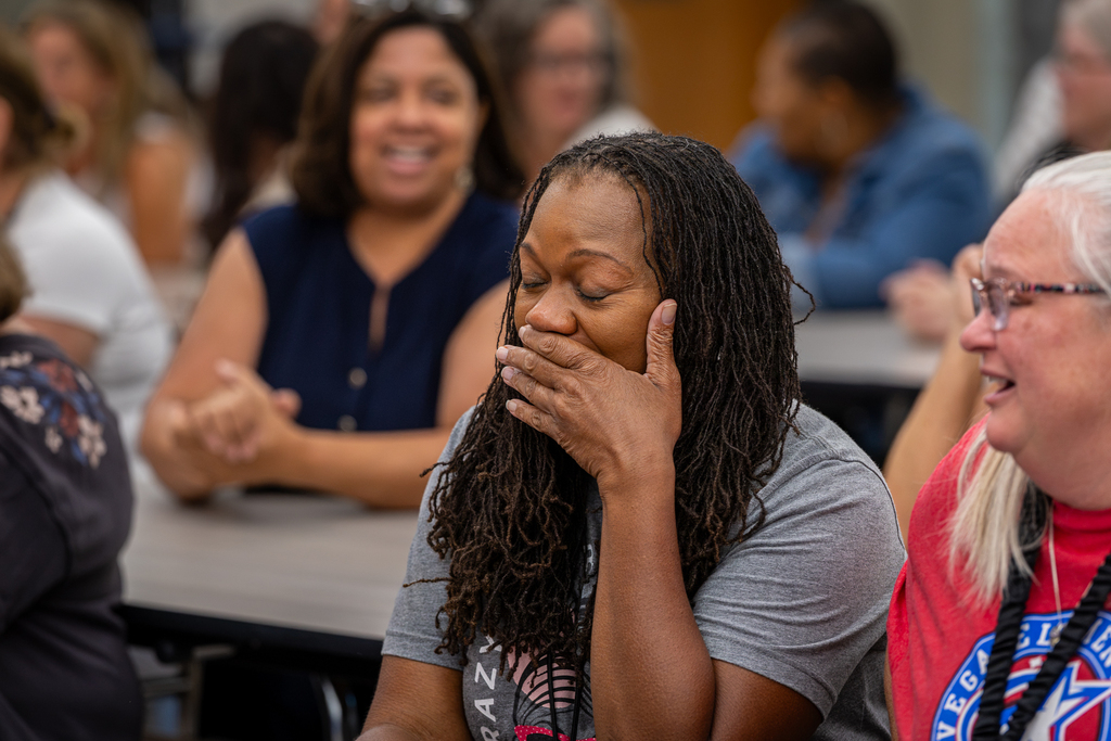teacher with eyes closed trying to hold back tears of joy