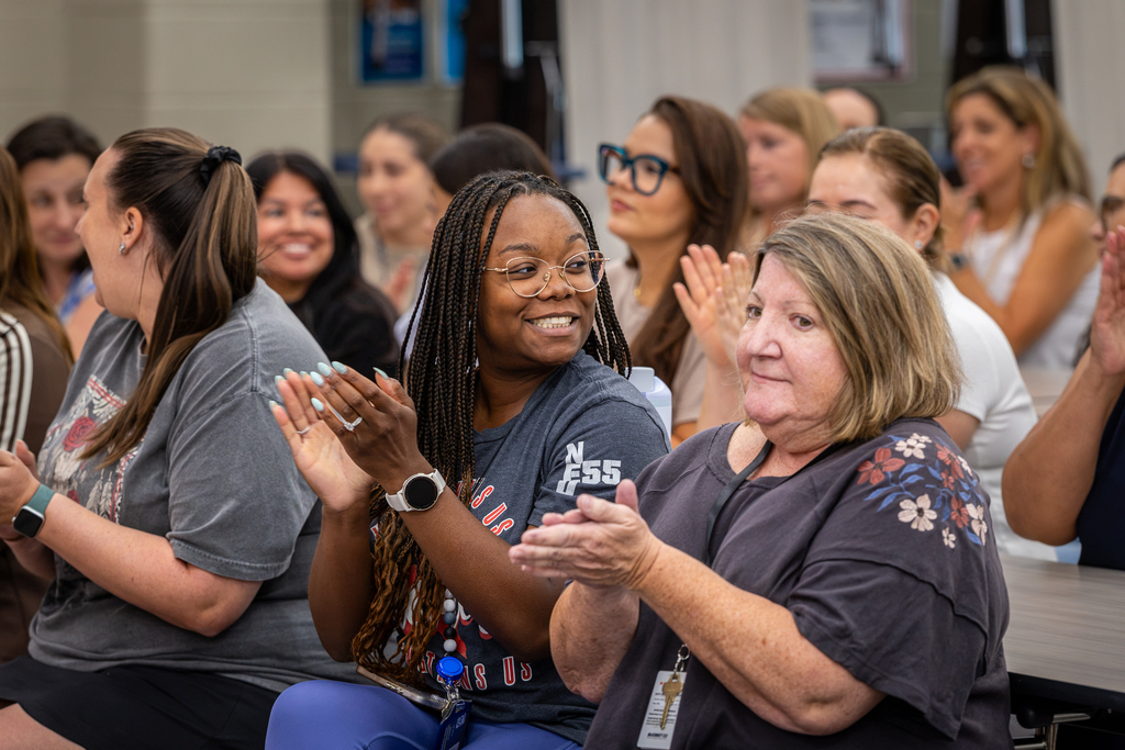 teachers clapping and smiling
