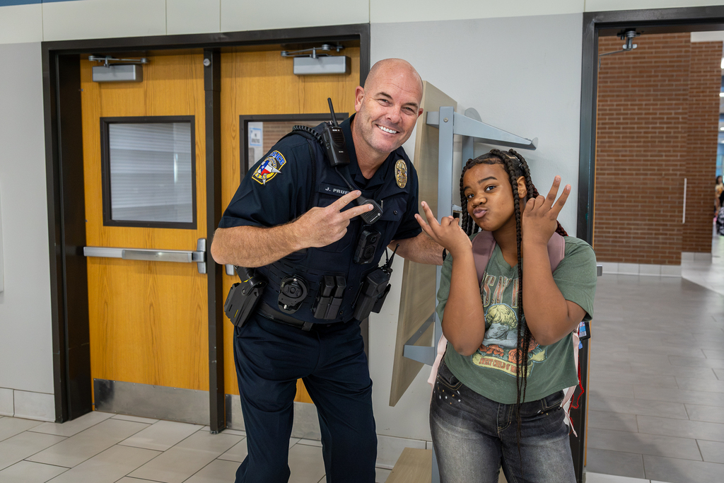 SRO and female student hamming it up for the camera at Evans Middle school