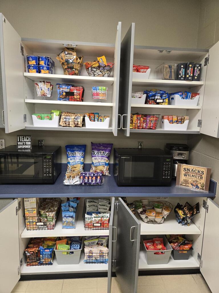 Picture of fully stocked pantry cabinets with lots of dried and shelf stable snacks and treats.