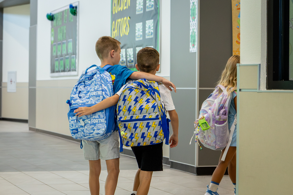two brothers heading to class with arms around shoulders
