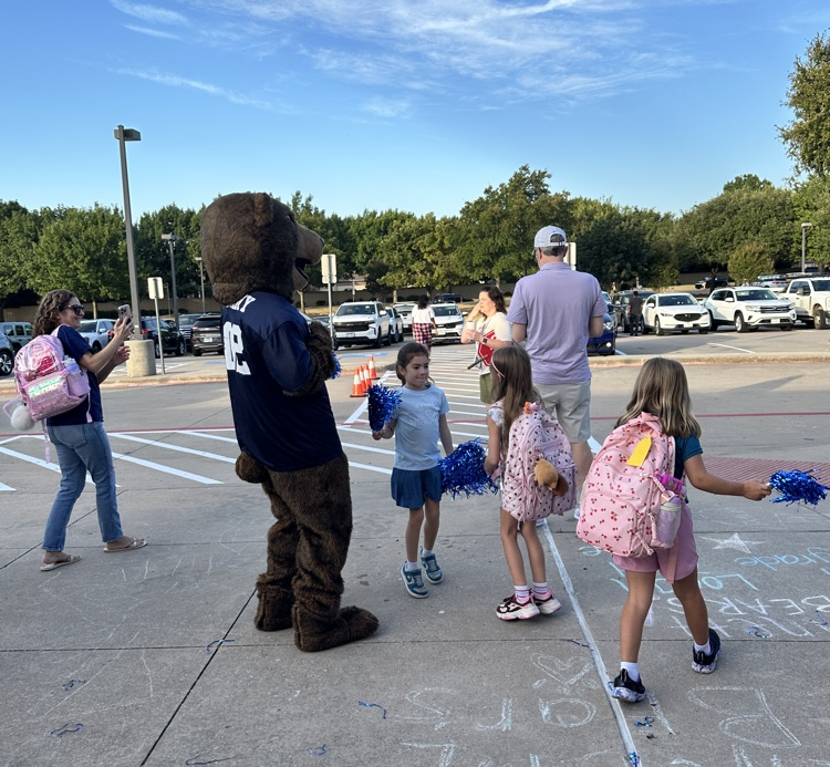 students celebrating with mascot Benny the Bear