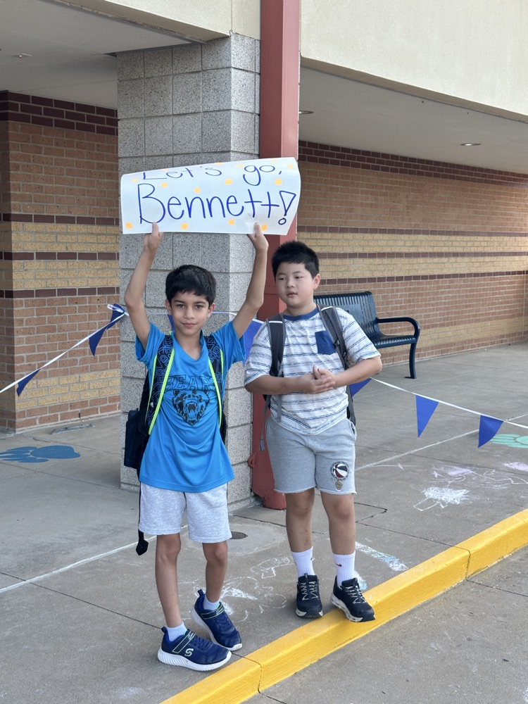 two students holding sign “Let’s go Bennett"