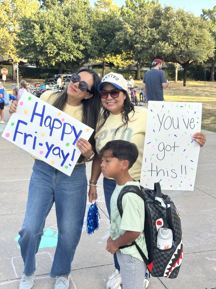 two PTO reps holding signs “happy fri-yay” and “you’ve got this