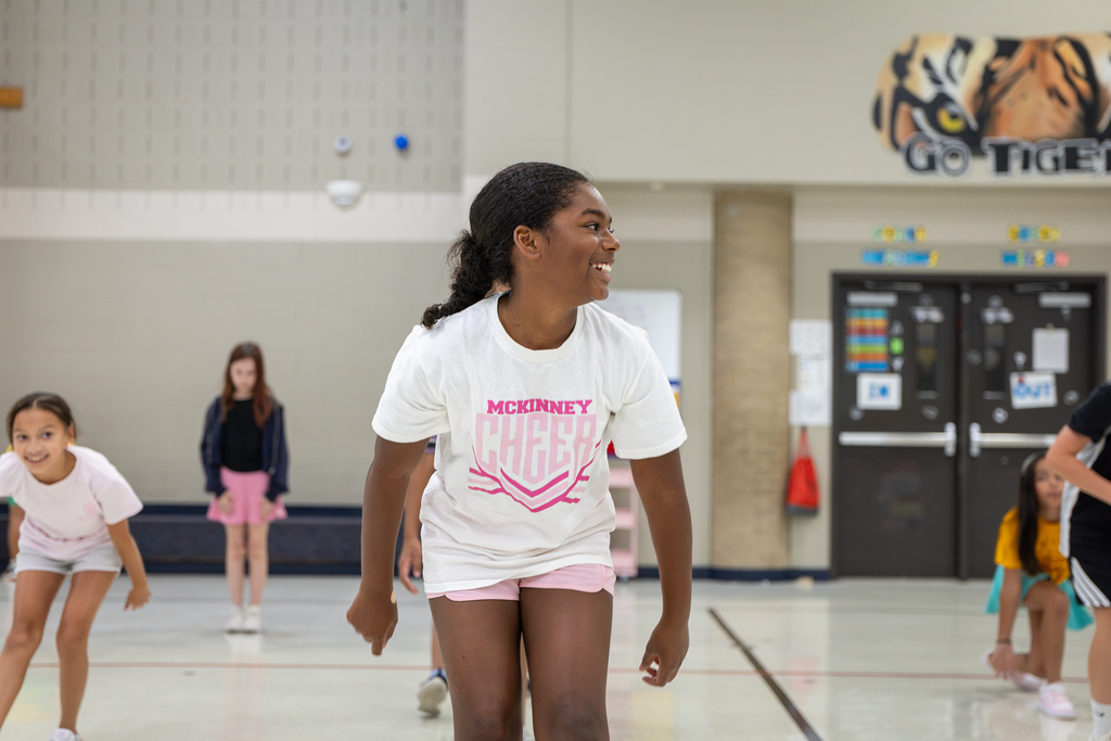 girl in gym doing exercises and smiling