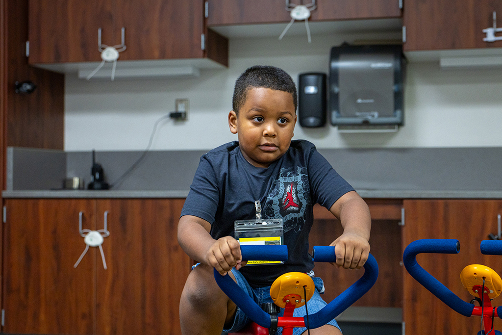 male Lawson student riding exercise bike