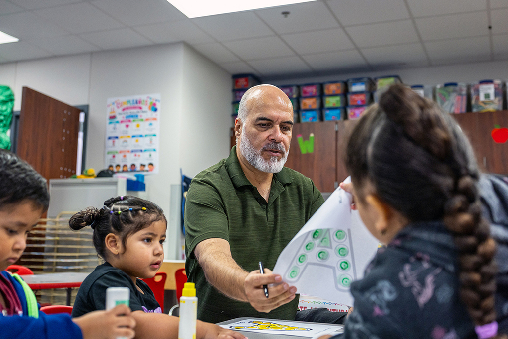 Lawson teacher looking at work of a student at their desk