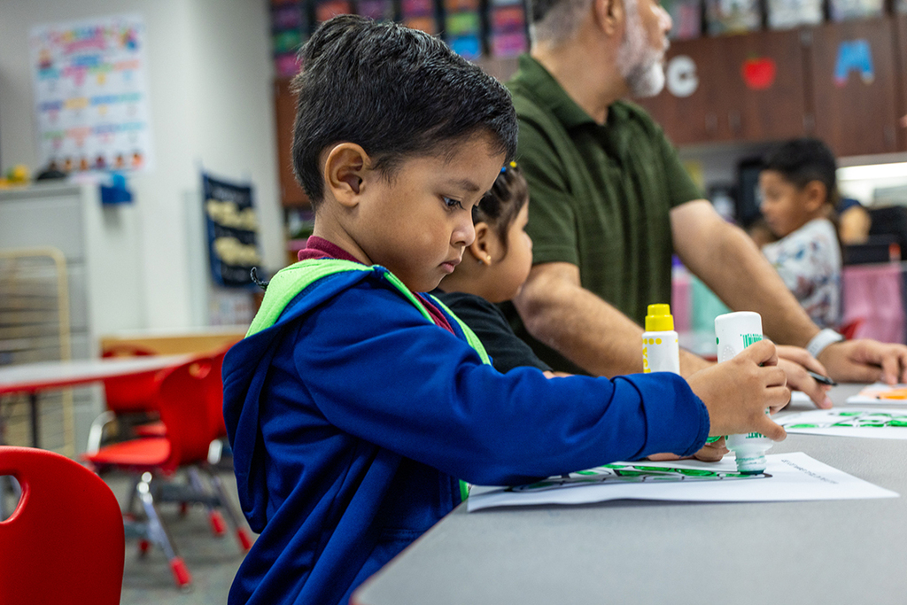 boy working with marker at desk