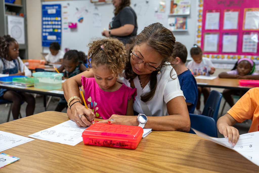 Rachel Corbin helping a student work on her letter formation