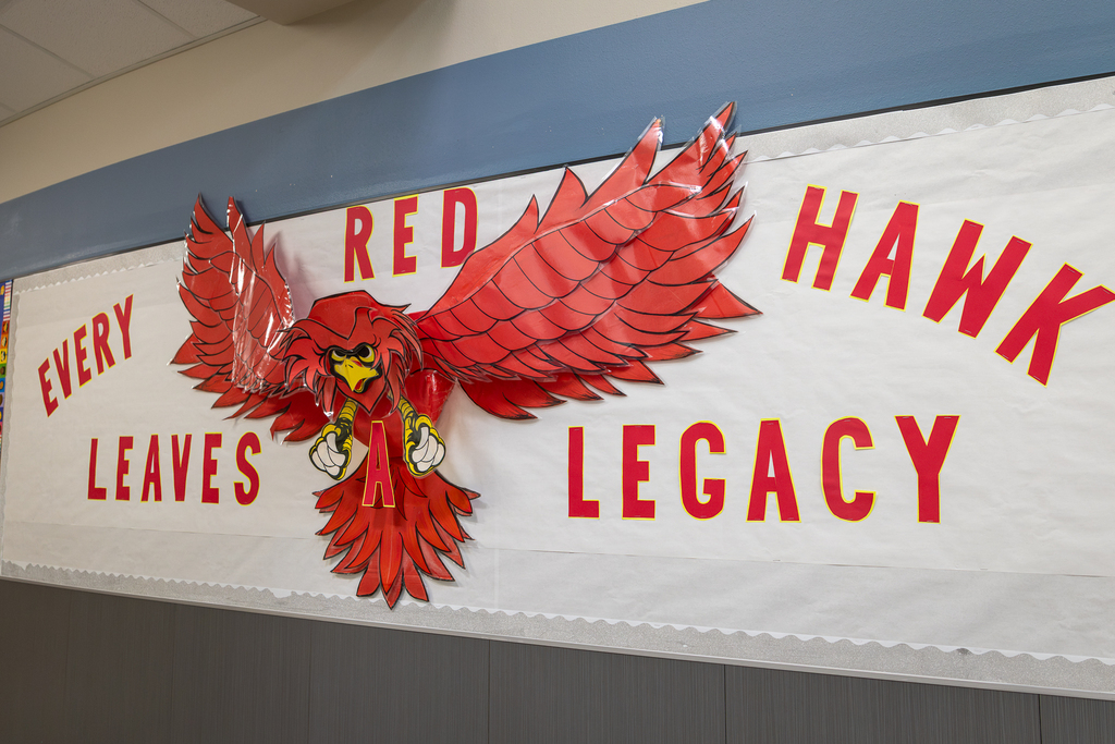 wall display that reads "Every Red Hawk Leaves a Legacy"