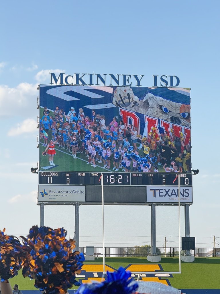 Picture of the MISD stadium screen displaying a group picture of Wilmeth elementary students and staff