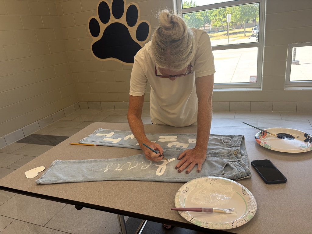 Mrs. Schindler painting her spirit jeans