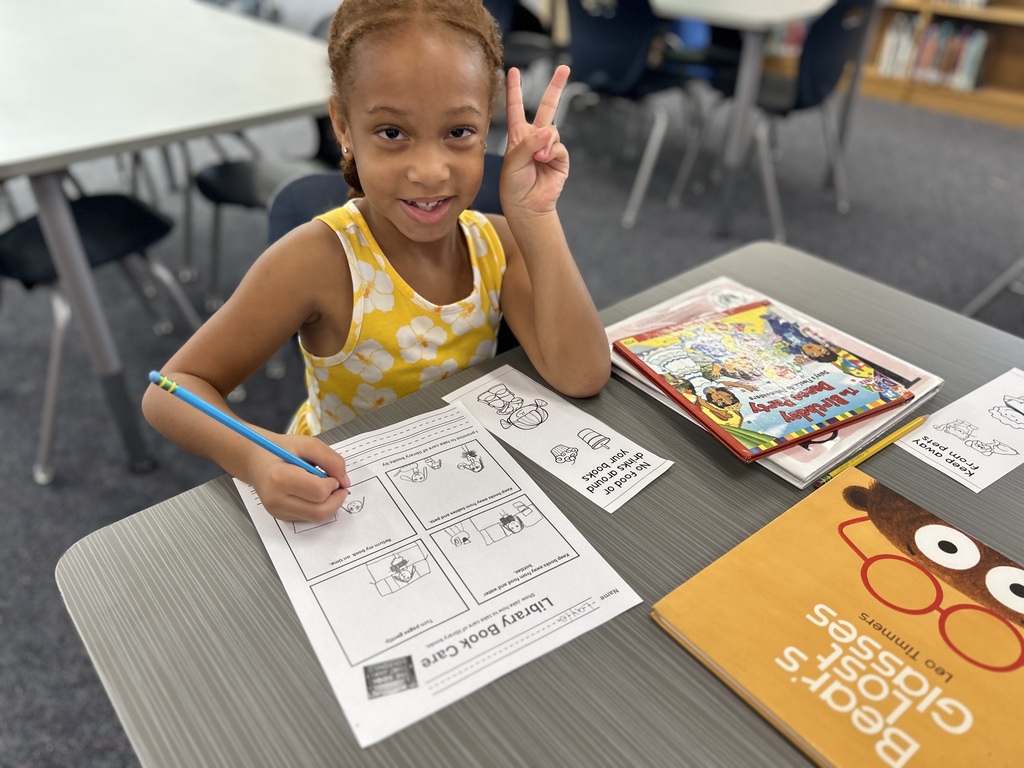Student learning about book care.