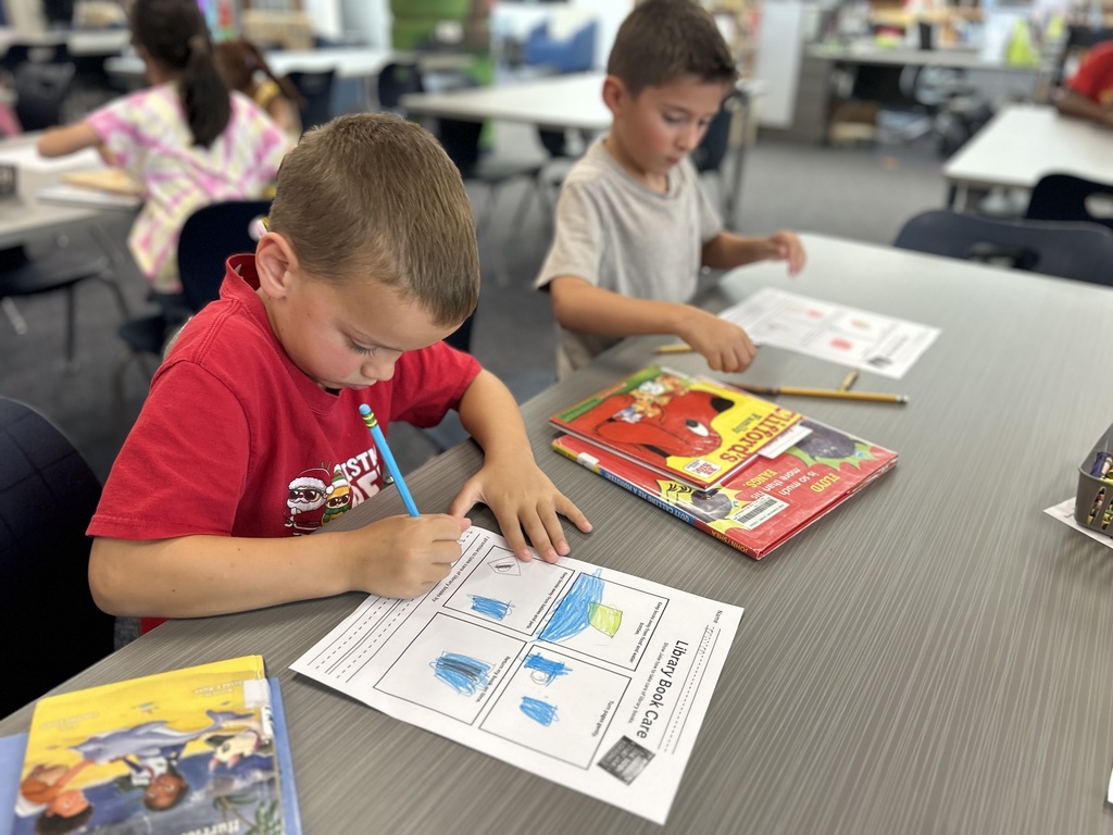 Students learning about book care.