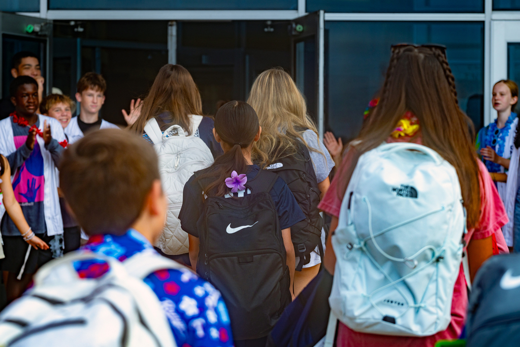 students walking into the building between the rows of PALS students