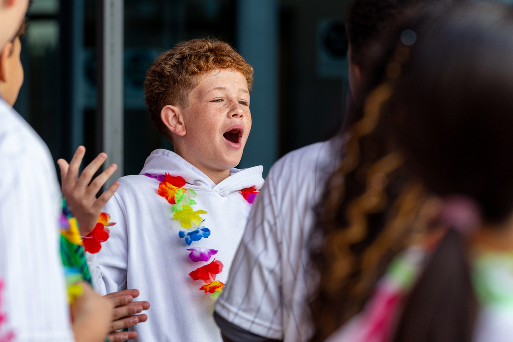 boy exclaiming with excitement as students walk up