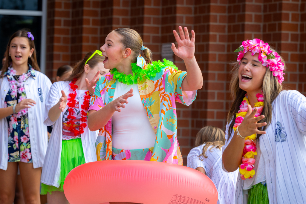girls dancing and cheering as students enter
