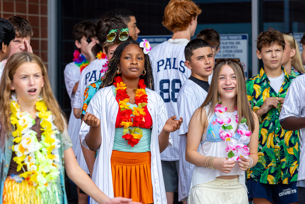 girls smiling and waiting for students to arrive