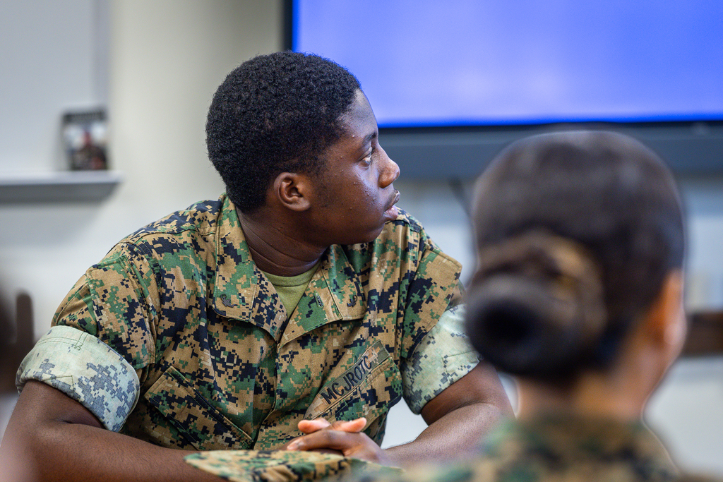 student in uniform looking over shoulder during instruction in jrotc