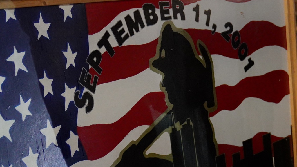 A graphic illustration of a fire responder on the background of a US flag.