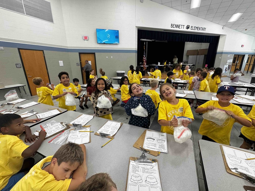 2nd graders at a several tables making ice cream - exploring matter changes